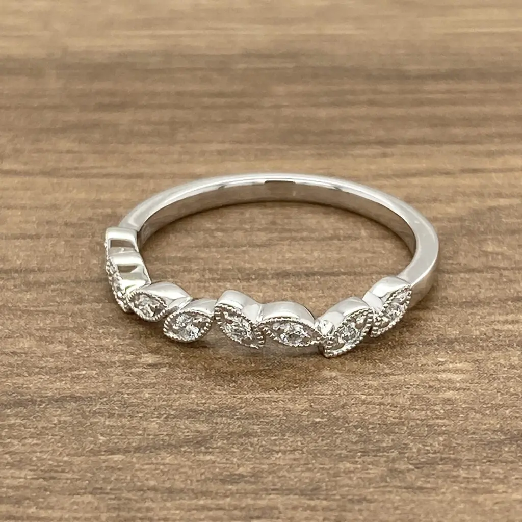 Silver ring with diamond leaf design.