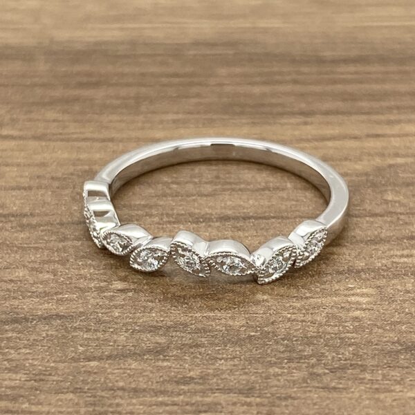 Silver ring with diamond leaf design.