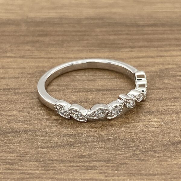 Diamond wedding band with leaf design.