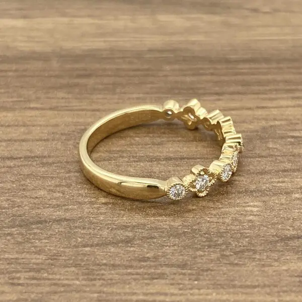 Gold band ring with diamond accents.