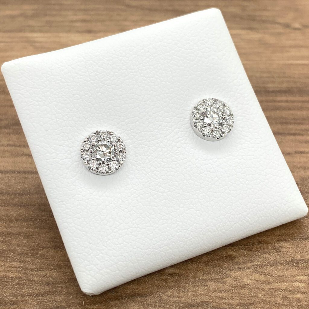 A pair of white gold diamond stud earrings.