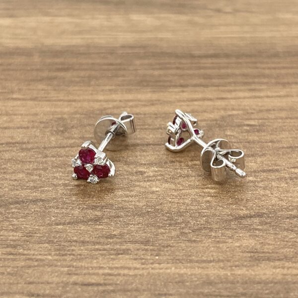 Silver stud earrings with ruby stones.