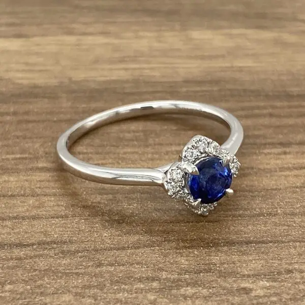 Silver ring with a blue sapphire and diamonds.