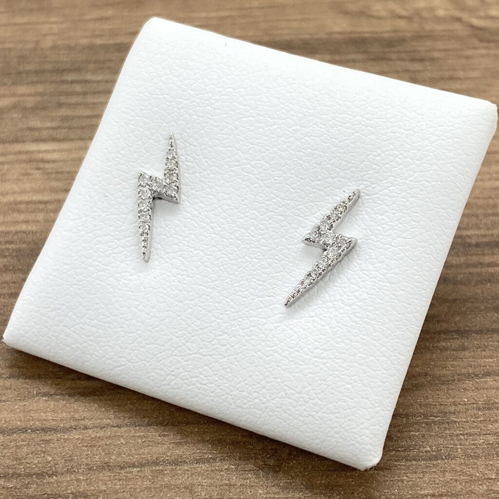 A pair of silver lightning bolt stud earrings.