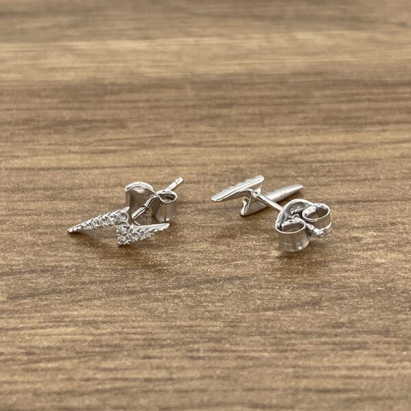 A pair of silver stud earrings with diamonds.