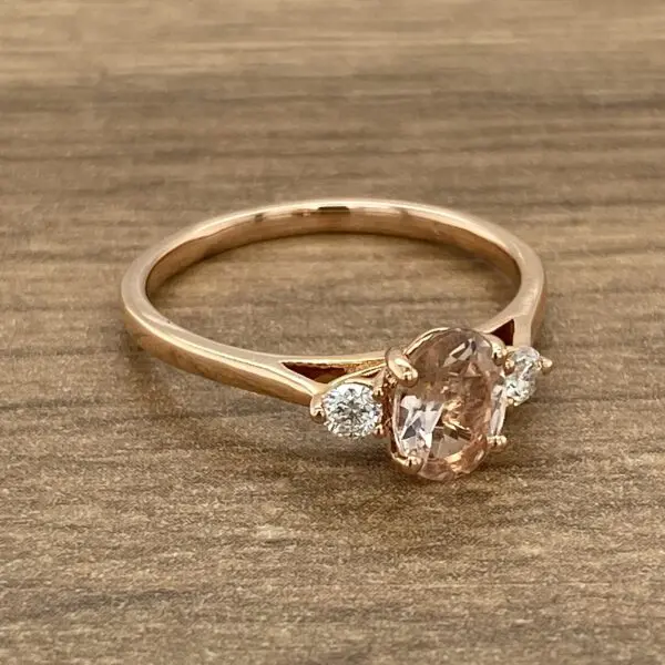 A rose gold ring with a morganite and diamonds.