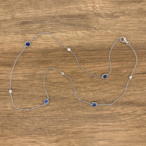 Silver chain necklace with blue sapphires and diamonds.