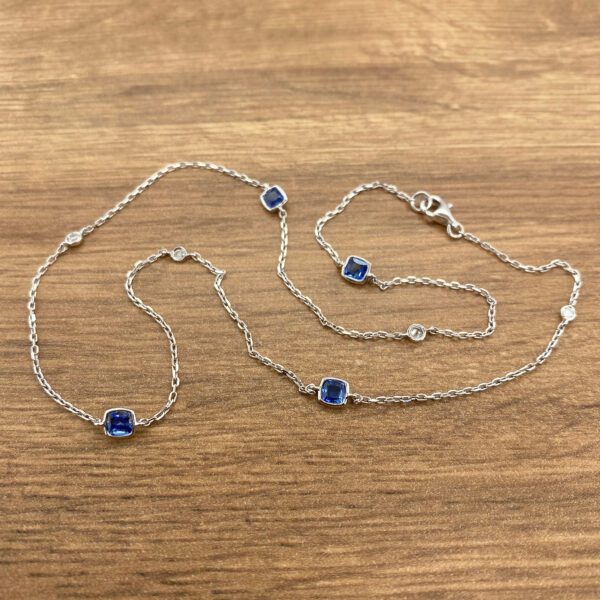 Silver chain necklace with blue sapphires.