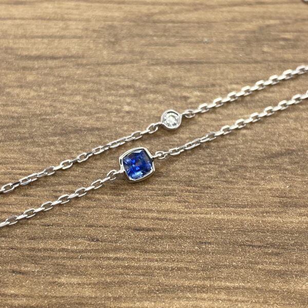 Silver chain with sapphire and diamond accents.