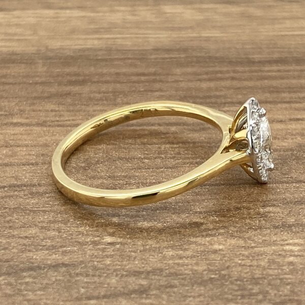 Gold ring with a diamond halo setting.