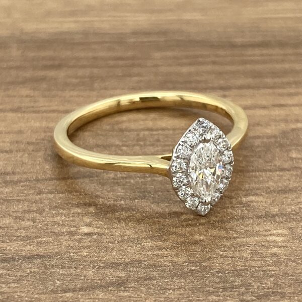 Gold engagement ring with marquise diamond.