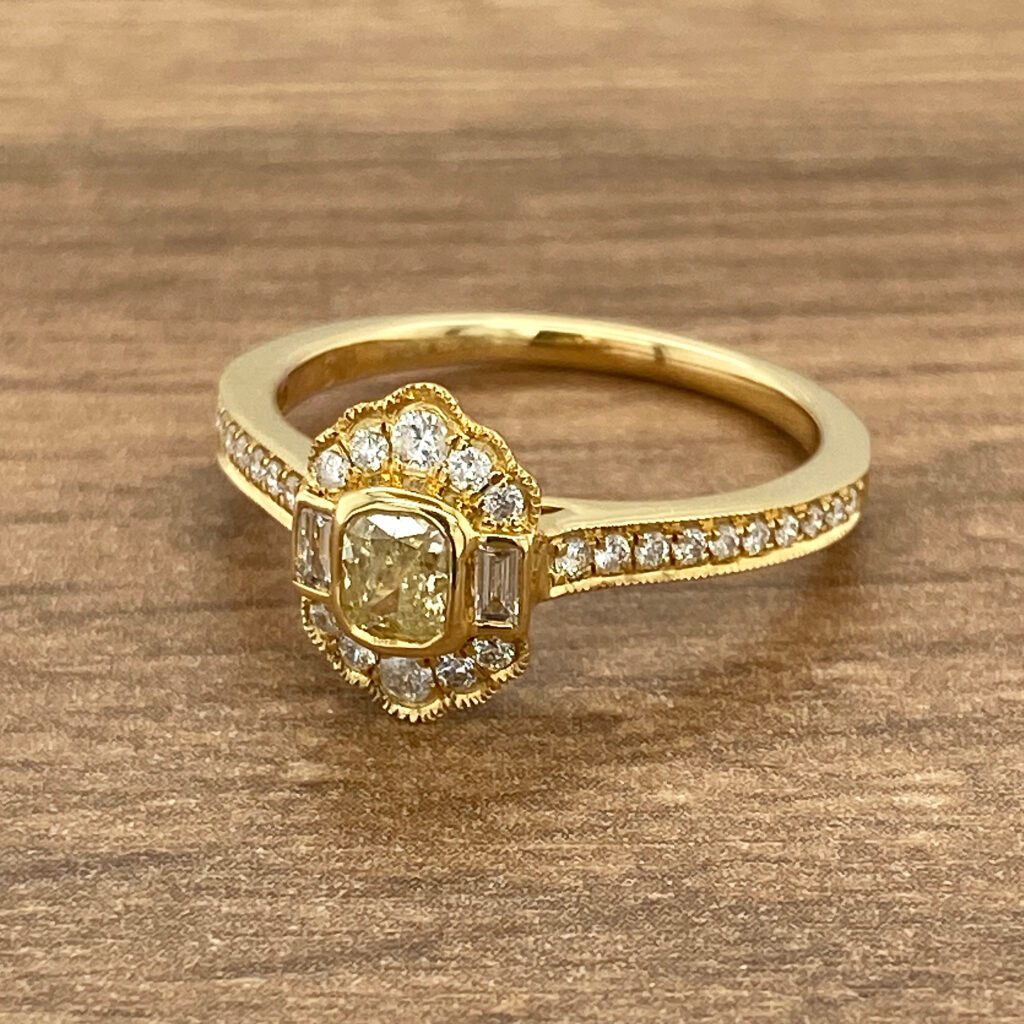 An engagement ring with a yellow diamond and diamond halo.