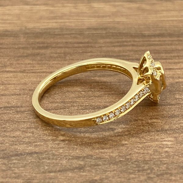 Gold ring with a diamond halo setting.