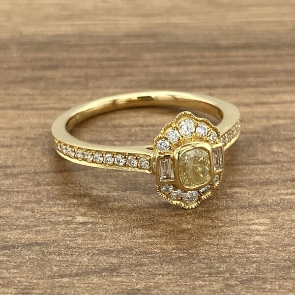 Gold ring with a yellow diamond.