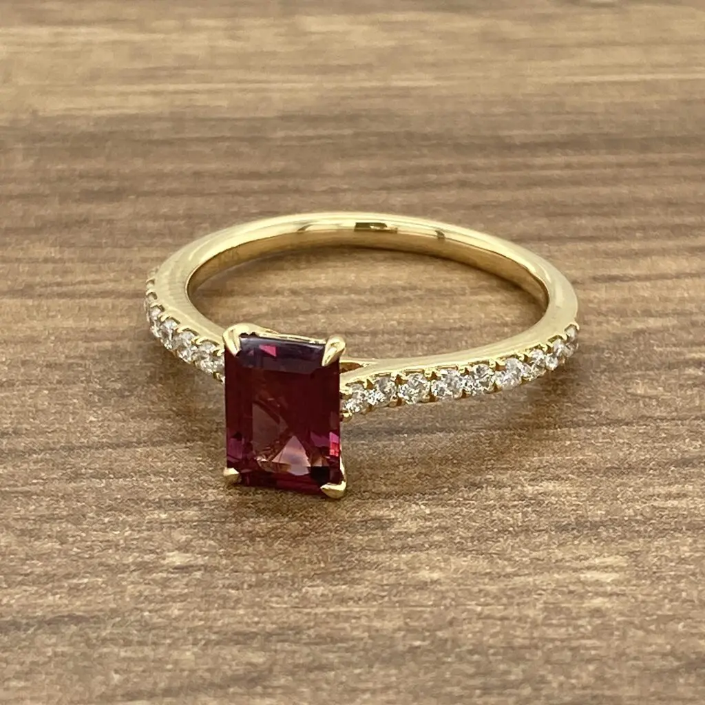 An emerald cut ruby and diamond ring.