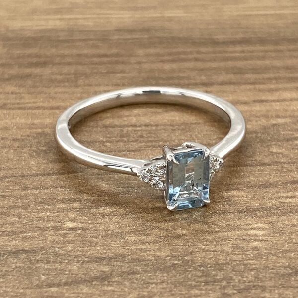 Aquamarine gemstone ring with diamond accents.