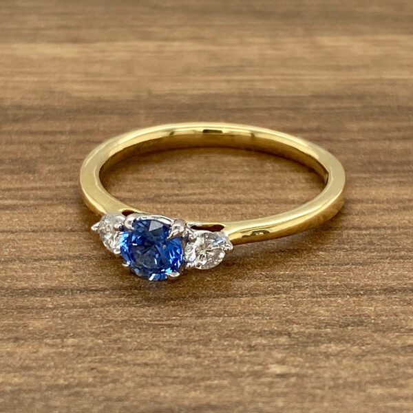 An engagement ring with a blue sapphire and diamonds.