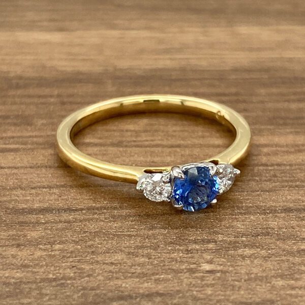 An engagement ring with a blue sapphire and diamonds.