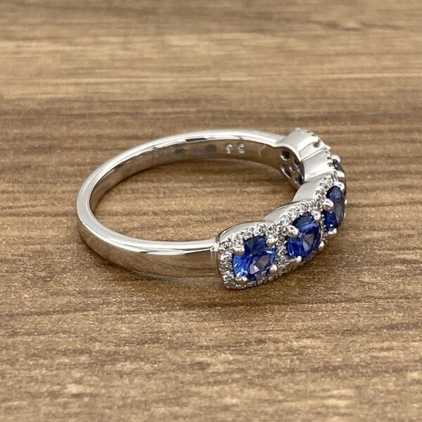 Silver ring with five blue sapphires.