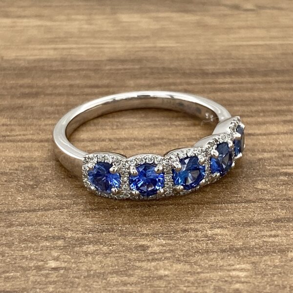 Silver ring with five blue sapphires.