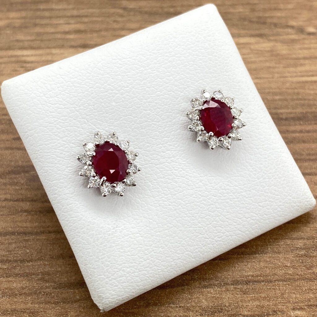 Ruby and diamond halo earrings.