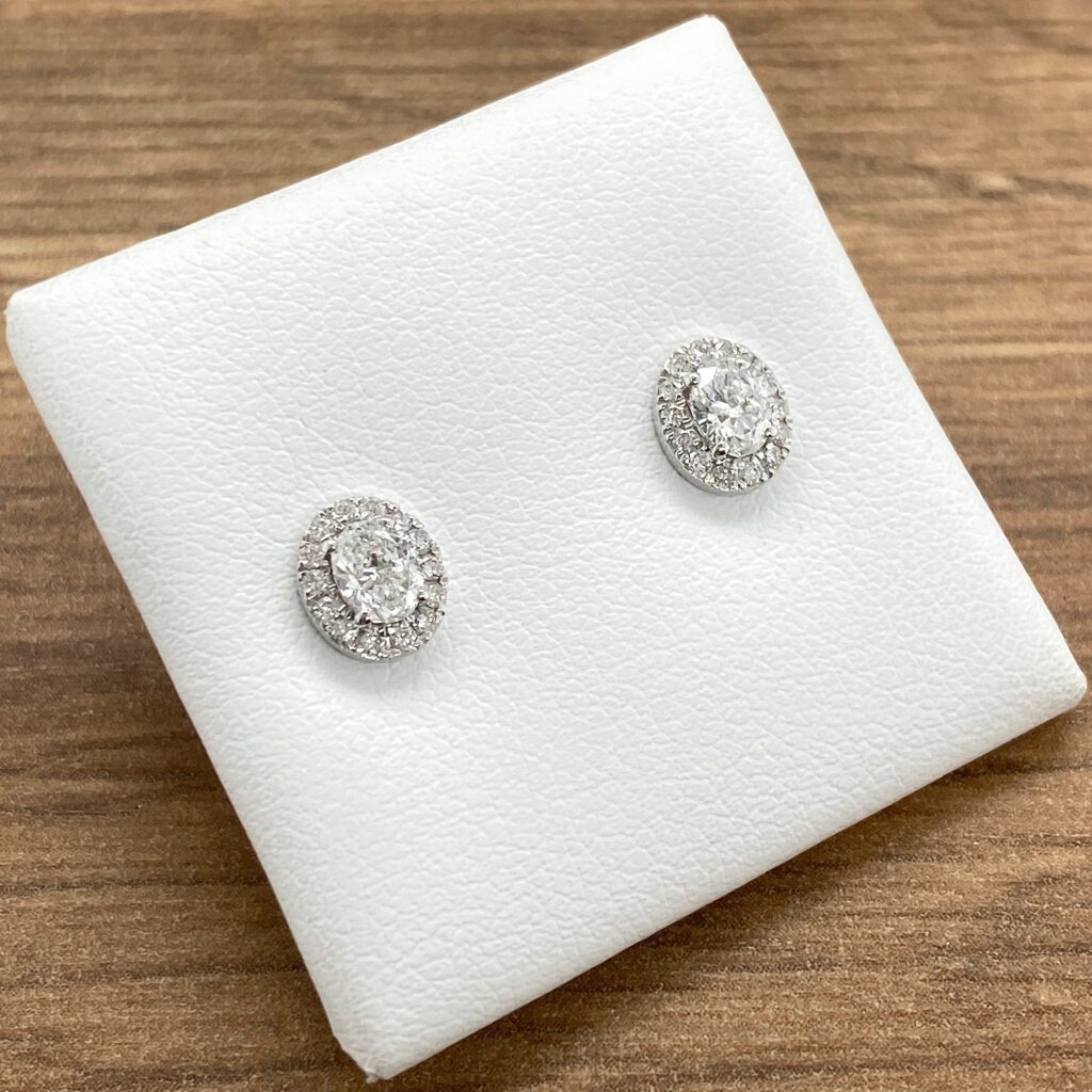 A pair of white gold diamond stud earrings.