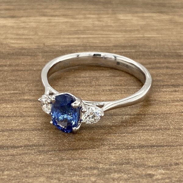 White gold ring with blue sapphire and diamonds.