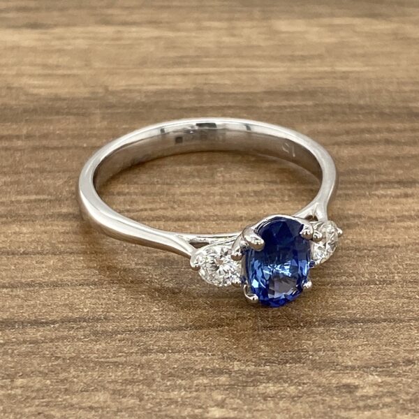 Silver ring with blue sapphire and diamonds.