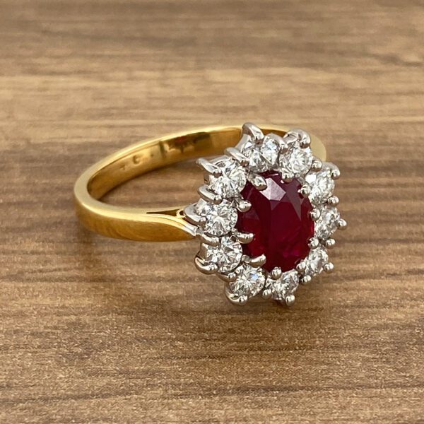 Gold ring with ruby and diamond halo.