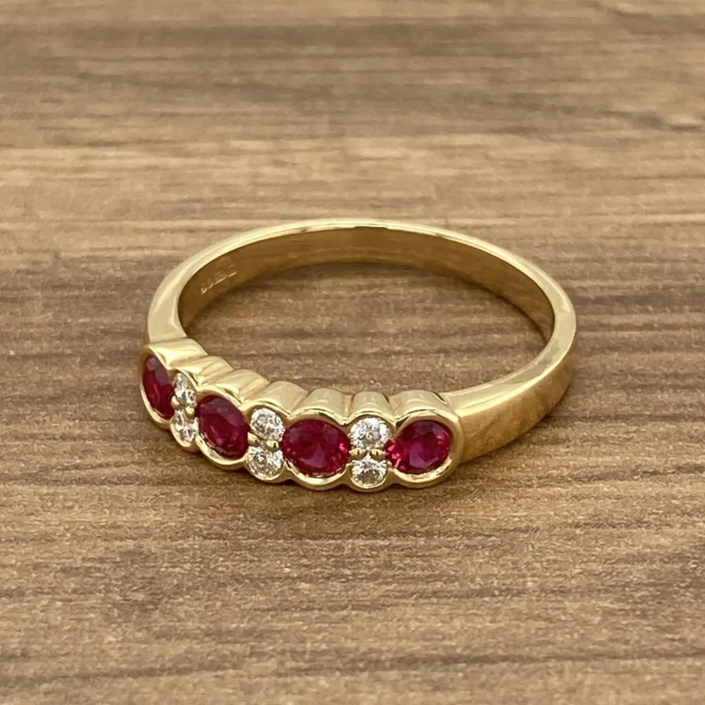 A gold ring with ruby stones and diamonds.