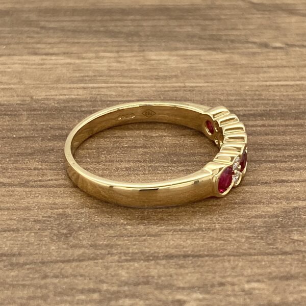 Gold ring with red and white stones.