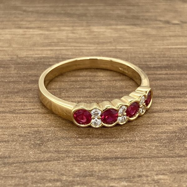 Gold band with ruby and diamond stones.