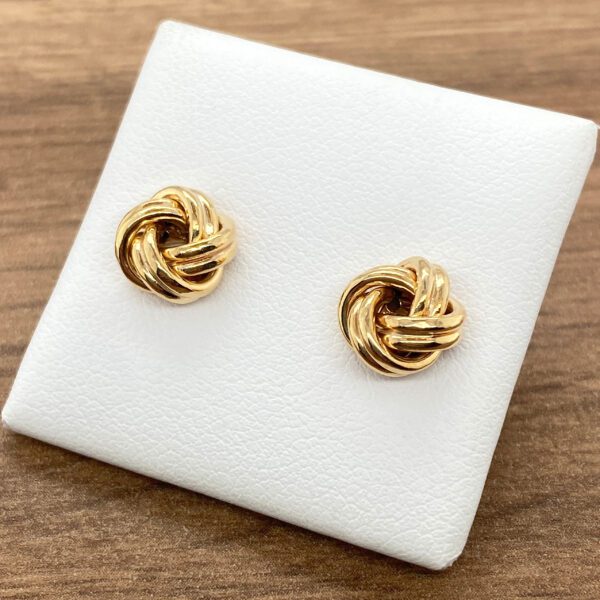 Pair of gold knot stud earrings.