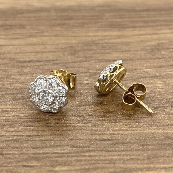 Gold and diamond flower stud earrings.