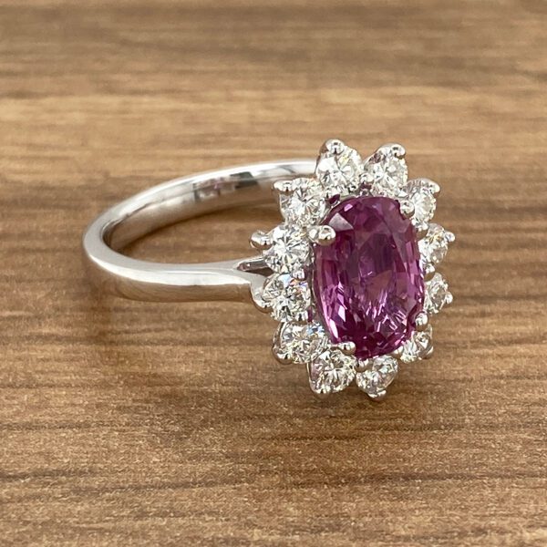 Oval pink sapphire ring with diamonds.