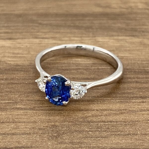 White gold ring with blue sapphire and diamonds.