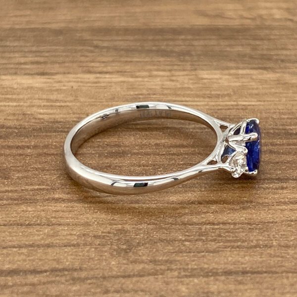 A silver ring with a blue sapphire.