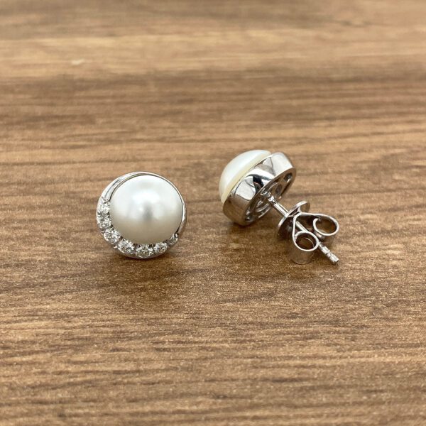 Pearl and diamond stud earrings.