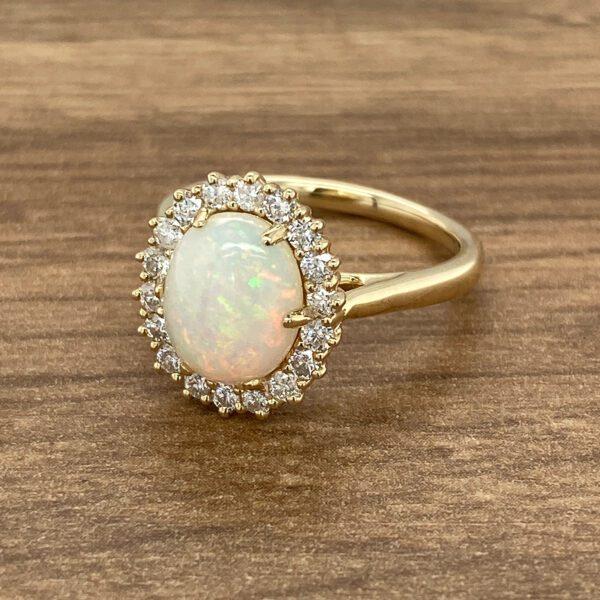 Gold ring with oval opal and diamonds.