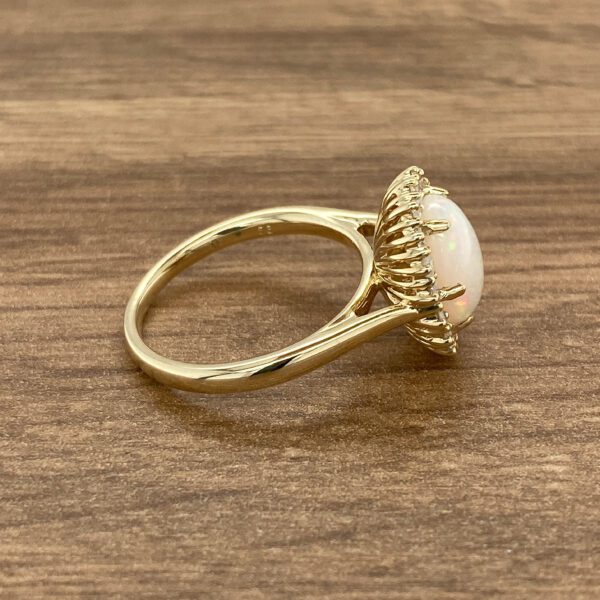 Gold ring with white opal and diamonds.