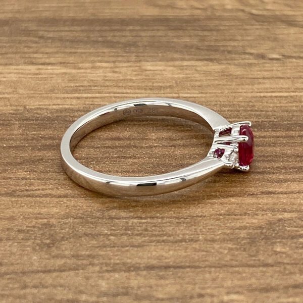 Silver ring with a ruby gemstone.