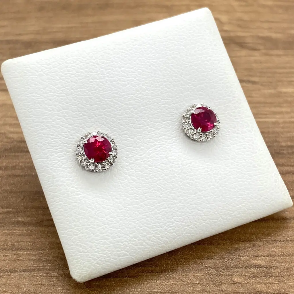 Ruby and diamond halo earrings.