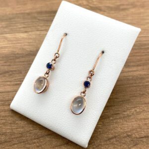 A pair of earrings with moonstones and sapphires.