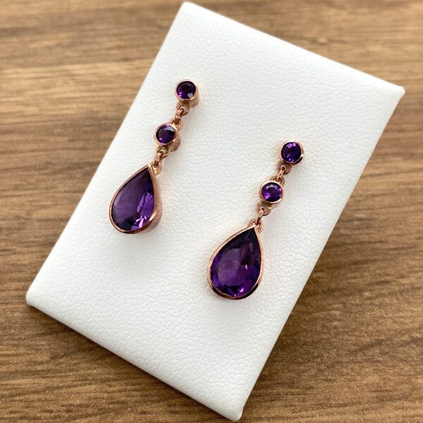 Rose gold earrings with amethyst stones.