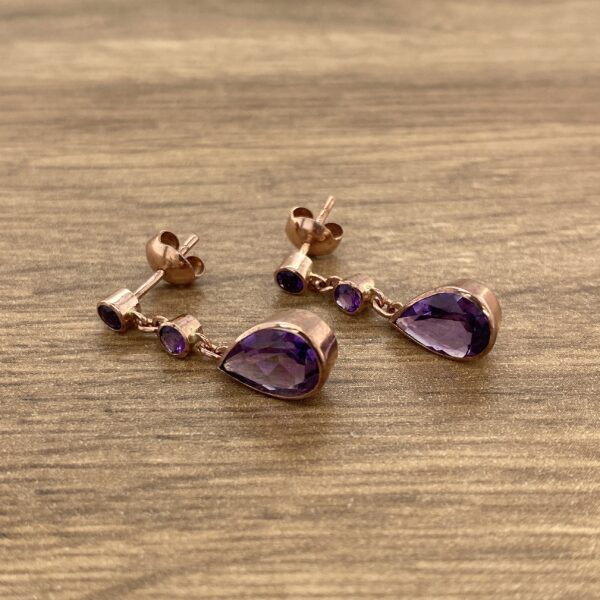 Rose gold earrings with amethyst stones.