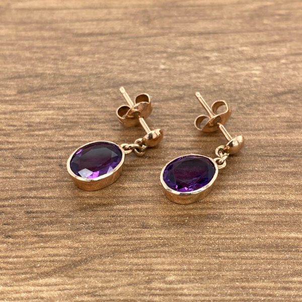 Rose gold earrings with amethyst stones.