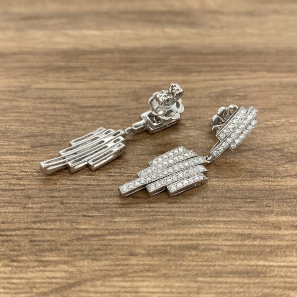 Diamond and silver geometric dangle earrings.