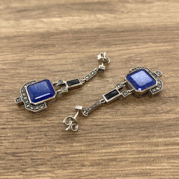 Silver earrings with blue gemstone and marcasite.