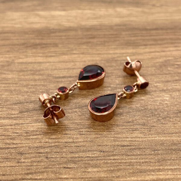 Rose gold teardrop garnet earrings.