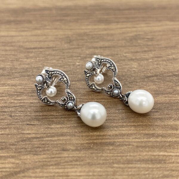 Pair of silver pearl drop earrings.